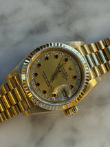 Rolex - Pre-owned Yellow Gold Lady-Datejust 26mm Champagne Ruby Diamond Dial 69178