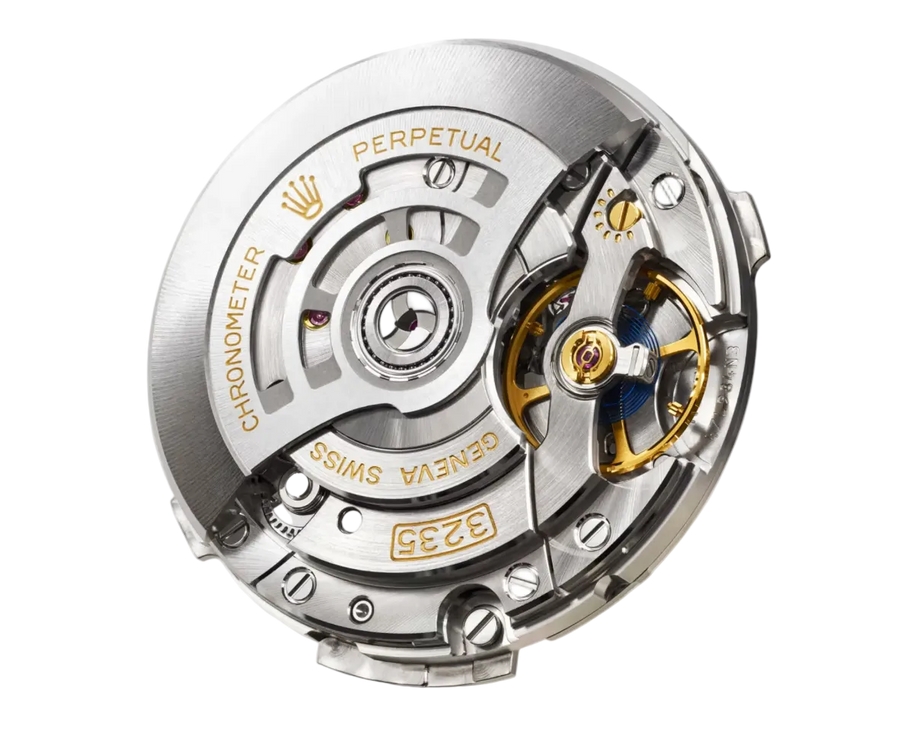 A close-up of a Rolex chronometer movement, showcasing the polished steel gears, bridges, and gold-toned lettering and jewels on a clean white background.